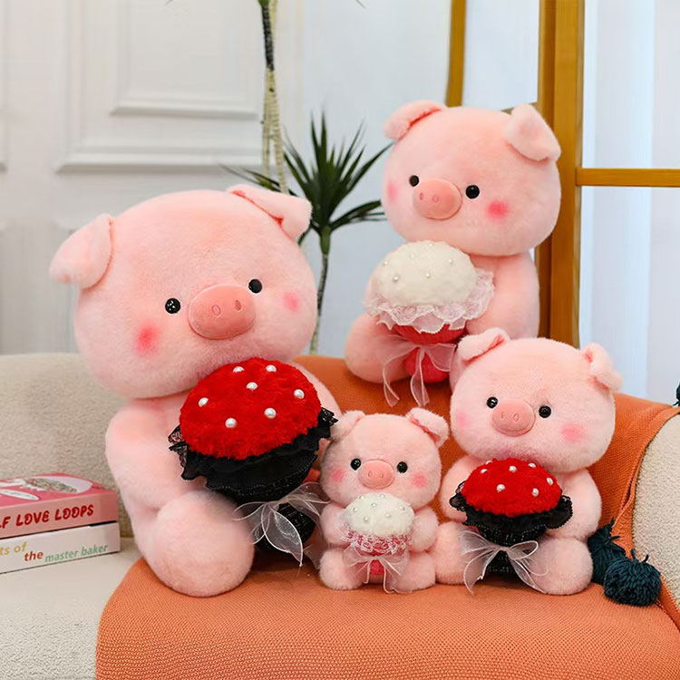 Peluche rosa con maialino che tiene i fiori